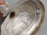 a person holding a silver object in their hand