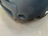 a close up of a car ' s front bumper with a hole in it