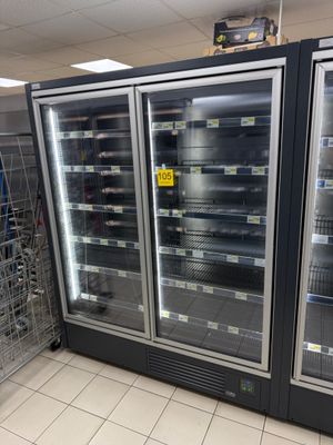 two refrigerators that are sitting in the middle of a store