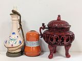 three vases and a vase on a shelf