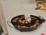 packaging of a black frying pan on a shelf in a store