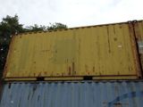 a yellow and blue container sitting on top of a blue and yellow container