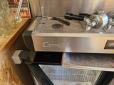 a coffee machine that is sitting in the corner of a kitchen