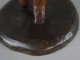 a bronze statue of a man riding a horse on a rock