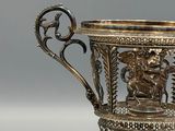 a silver cup that is sitting on a table