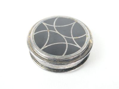 a black and white picture of a button on a white surface