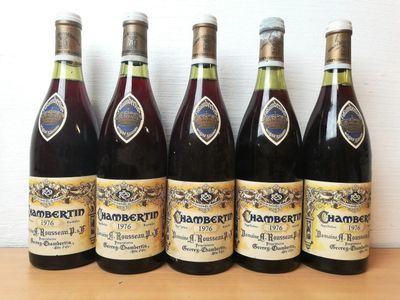 six bottles of wine are lined up on a table