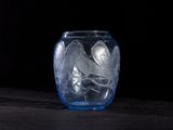 a glass vase with a lot of ice in it on a table