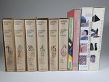 several books are stacked on top of each other on a table