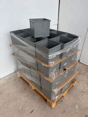 a stack of plastic containers sitting on a pallet