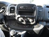 a dashboard view of a car with a radio and a steering wheel