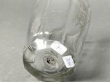 a glass bottle with a label on it sitting on a table