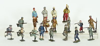 many figurines of soldiers standing on a white surface