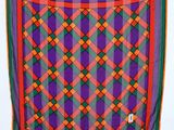 an image of a colorful plaid scarf hanging on a wall