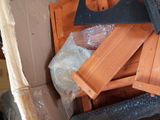 a pile of wooden furniture in a room that is under construction