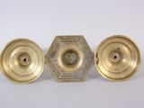three antique brass candlesticks on a white background