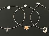 a pair of hoop earrings with a flower on each side