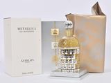 un flacon de parfum Metallica à côté d'une boîte