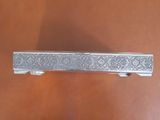 an antique silver plate with a decorative design on it