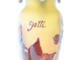 a yellow vase with a picture of a bird and flowers on it