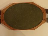a small wooden table with a green cloth on it