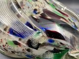a glass sculpture of a bird that is sitting on a table
