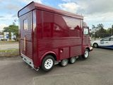 a red food truck that is parked in a parking lot