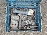 a blue tool box with tools in it on the ground