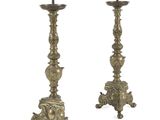pair of antique brass candlesticks on pedestals