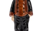 a figurine of a man wearing a hat and jacket