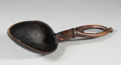 a close up of a spoon with a handle on a white surface