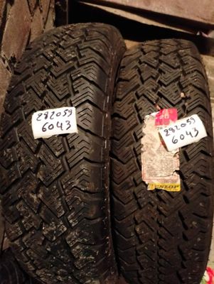 two tires with stickers on them sitting next to each other