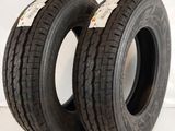a pair of two tires on a white surface with a red background