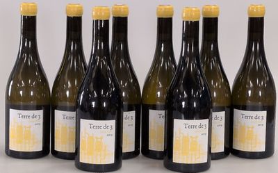 six bottles of wine are lined up on a table