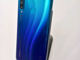 a close up of the back of a blue and black phone