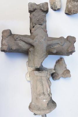 a cross made out of cement on a white surface