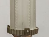 a white candle that is sitting on a wooden table