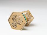 a close up of a gold ring on a white surface