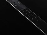 a close up of a remote control on a black surface