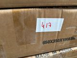a cardboard box with a sticker on it sitting on top of a pile of boxes