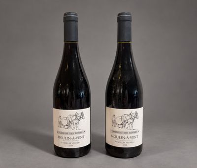 two bottles of wine sitting next to each other on a table
