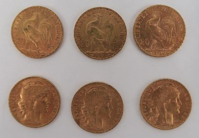 six different types of gold coins on a white surface