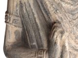 an old statue of a man holding a baby in his arms