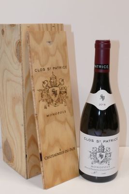 a bottle of wine sitting next to a wooden box