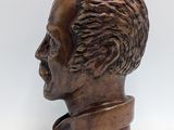 bronze bust of a man with a beard on a white background