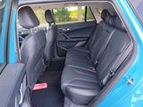 the back seats of a blue car with black seats in it