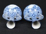 two blue and white vases sitting next to each other