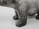 a small statue of a polar bear on a white surface