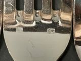 three forks that are sitting next to each other on a table
