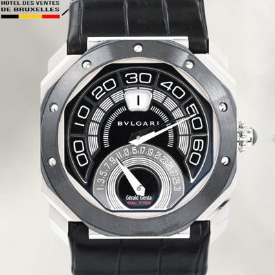 a close up of a watch with a black face